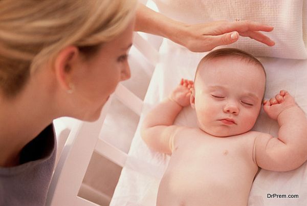 baby sleeping and mother taking care