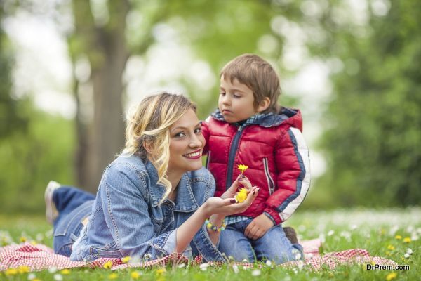 Boy Putting Flowers in Mother's Hair