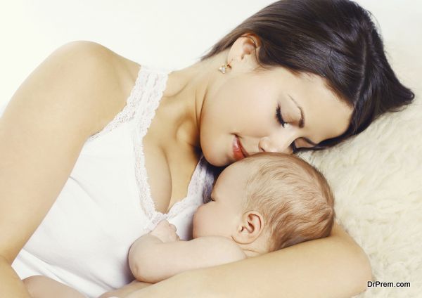 Closeup portrait of young mother sleeping with baby at home