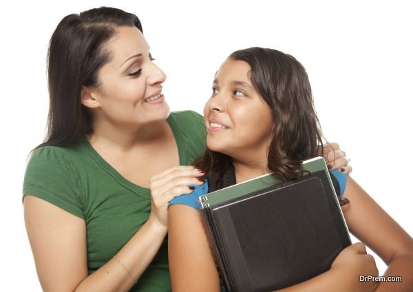 Hispanic Mother and Daughter Ready for School Isolated on a White Background.