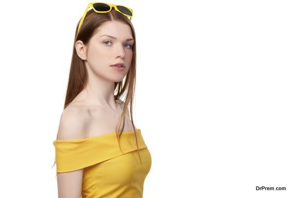 Redheaded female in yellow top and sunglasses