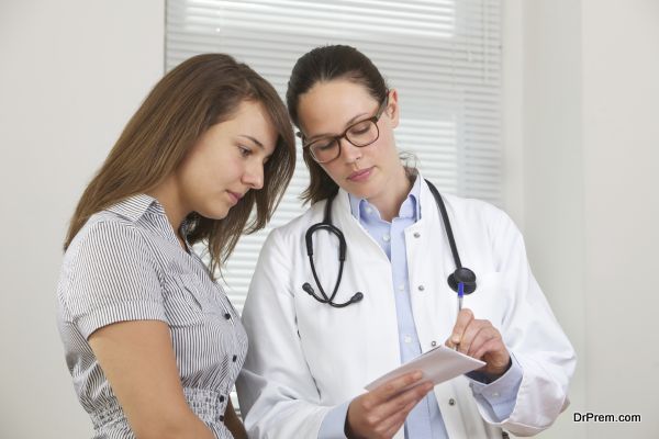 Doctor showing notes to young patient